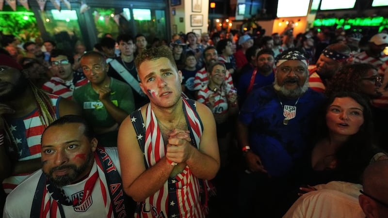 Tommy Floeter, center, and other United States fans with the American Outlaws supporters group...