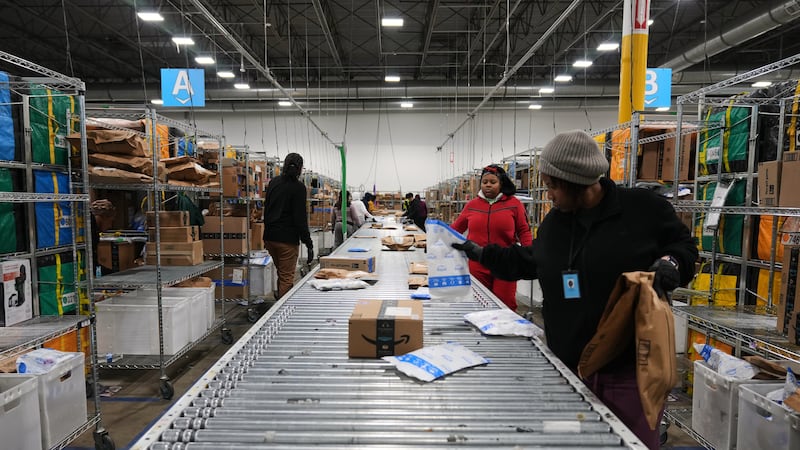Amazon employees sort packages at a last-mile delivery center in Seaford, Del., Wednesday,...