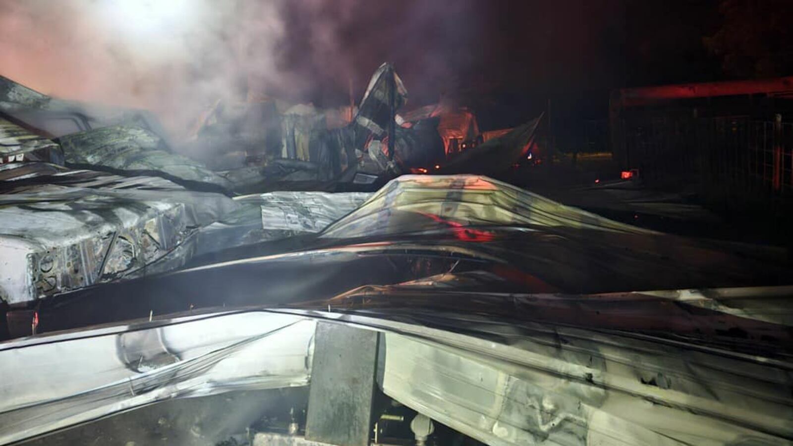 Shop Building Fire Crews respond to shop building fire, vehicles inside