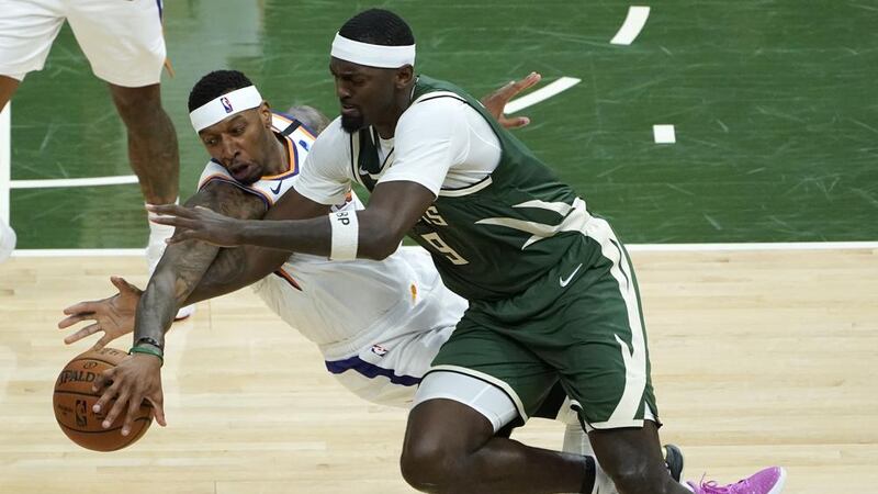 Phoenix Suns forward Torrey Craig (12) and Milwaukee Bucks center Bobby Portis (9) battle for...