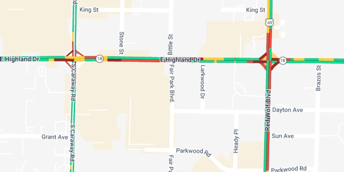 Car on its side blocks eastbound lanes at Highland Drive and Fairpark Boulevard