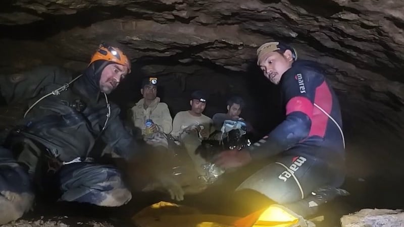 This image released by Benz Norrased Palasing Seascout Diving, two rescuers work before...